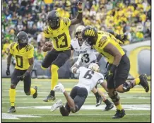  ?? Associated Press ?? Oregon quarterbac­k Anthony Brown (13) eludes a tackle by Colorado cornerback Mekhi Blackmon (6) during the third quarter on Saturday in Eugene, Ore. Oregon plays Washington in Pac-12 play on Saturday.