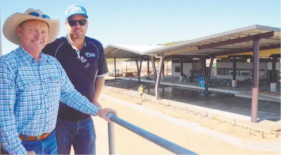  ?? ?? Towers Jockey Club president Rob Kirkwood and RJG project manager Joe Painter marvel at the new roof extension to the club facilities that is part of the major renovation­s at the site. Picture: Trudy Brown