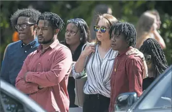  ?? Stephanie Strasburg/Post-Gazette photos ?? People wait in line at the viewing of 17-year-old Antwon Rose II on Sunday at Tunie Funeral Home in Homestead.