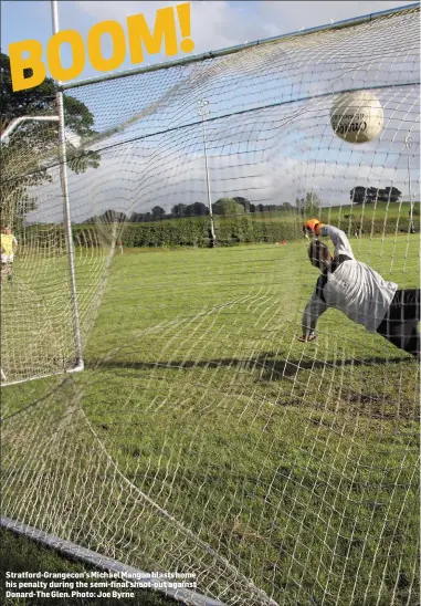  ??  ?? Stratford-Grangecon’s Michael Mangan blasts home his penalty during the semi-final shoot-out against Donard-The Glen. Photo: Joe Byrne