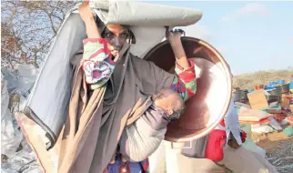  ??  ?? A drought-displaced Somali woman arrives at a camp in the Kaxda area on the outskirts of Mogadishu Friday. (AP)