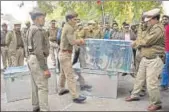  ?? PTI ?? Police personnel carry the boxes of demonetise­d notes recovered after the raid in Kanpur on Wednesday.