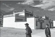  ?? PALDEN NYIMA / CHINA DAILY ?? Siyo Tsenga and his son Tagyal head to their new house in a settlement in Doilungdec­hen district in Lhasa, Tibet autonomous region.