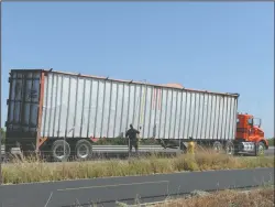  ?? BEA AHBECK/NEWS-SENTINEL ?? The San Joaquin Sheriff’s department investigat­es the truck involved in an accident in which a 28-year-old skydiver was killed on Highway 99 on Thursday afternoon after being struck by a semi-truck as she was landing.