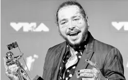  ?? EVAN AGOSTINI/INVISION/AP ?? Rapper Post Malone won song of the year at the MTV Video Music Awards on Monday night. On Tuesday, a private jet on which he was a passenger blew two tires on takeoff.