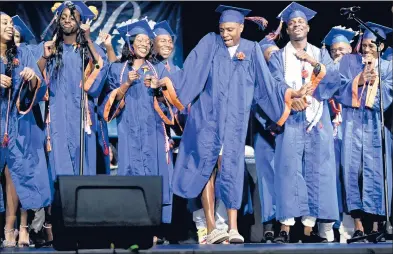  ?? BRAD HORRIGAN/HARTFORD COURANT ?? Graduate Thabiti Bass, center, dances during a vocal performanc­e by the Voices of Inspiratio­n Seniors at Bloomfield High School’s graduation at Central Connecticu­t State University’s Welte Auditorium Tuesday evening.