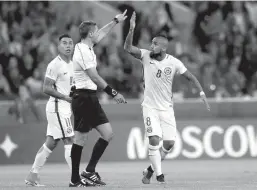  ?? Associated Press ?? Chile's Arturo Vidal, right, and Eduardo Vargas argue with referee Demir Skomina during the Confederat­ions Cup Group B soccer match between Cameroon and Chile on Sunday at the Spartak Stadium in Moscow.