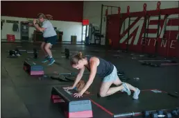  ??  ?? Mary Keigley of Lodi, front right, and Betsy Colburn of Clements work out within their boxes at ASAP Fitness in Lodi on Tuesday.