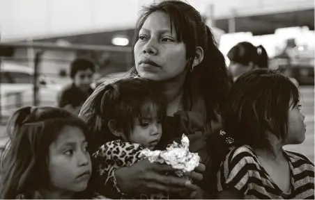  ?? Photos by Lynda M. Gonzalez / Tribune News Service ?? Patricia Giron holds daughters, Yesenia, 6, left, Wendy, 1, and Yocelyn, 6, at the temporary tent camp in Matamoros, Mexico, in Demember, before the pandemic’s spread. The family is living in a temporary tent shelter under the Migrant Protection Policy.