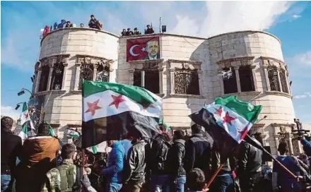  ?? AFP PIC ?? Syrians demonstrat­ing in the rebel-held town of Azaz in northern Syria on Friday in support of a joint rebel and Turkish military operation against Syrian-Kurdish forces in Afrin.