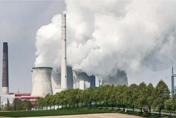  ??  ?? A coal-fired RWE power plant steams on a sunny day in Neurath, Germany, yesterday. Germany's top court ruled yesterday that the country's government has to set clear goals for reducing greenhouse gas emissions after 2030, arguing that current legislatio­n doesn't go far enough in ensuring that climate change is limited to acceptable levels. Photo: AP