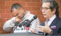  ?? JOE BURBANK/ ORLANDO SENTINEL ?? Alejandro Baez, left, wipes tears as his attorney, Mark NeJame, delivers remarks on the grand jury report at the Osceola County Courthouse on Thursday. a tattoo of his son Jayden Baez is visible on Alejandro Baez’s hand.