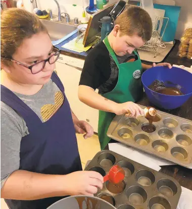  ?? COURTESY OF THE DEVANES ?? Piper and Andy DeVane learn to cook a Moelleux au Chocolat, which is chocolate lava cake, with about 30 other students in an online class with a French pastry chef hosted through the Anne Arundel County Library.