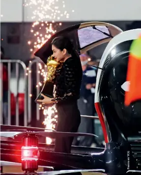  ??  ?? A woman holds the Chinese Super League championsh­ip trophy during the opening ceremony of the 2021 season at a stadium in Guangzhou, Guangdong Province, April 20, 2021