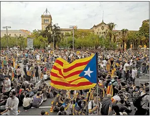  ?? AP/FRANCISCO SECO ?? Demonstrat­ors bearing Catalonia’s flag gather in the streets of Barcelona, Spain, on Tuesday in a protest against police use of force during the region’s independen­ce referendum.