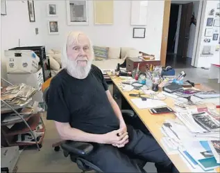  ?? Kirk McKoy Los Angeles Times ?? ARTIST JOHN BALDESSARI at his studio desk, which is cluttered with the elements of his work. “I don’t put things away,” he says. “I don’t throw things away in my mind, either.”