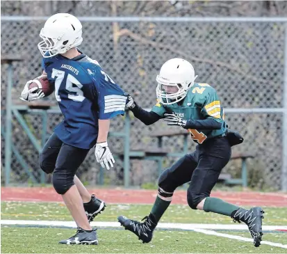  ?? CLIFFORD SKARSTEDT EXAMINER FILE PHOTO ?? The Argonauts’ Sam Levasseur eludes pressure from the Eskimos’ Spencer Watchorn during the Kinsmen Minor Football League in 2017. Like many other local football players, they’ve heard from both of Peterborou­gh’s youth football organizati­ons.