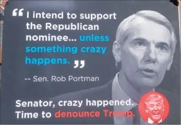  ?? Dan Sewell Associated Press ?? A POSTER at a news conference by the Ohio Democratic Party calls on GOP Sen. Rob Portman to denounce Donald Trump. Ohio, a key swing state, may be the most important battlegrou­nd in Trump’s campaign.