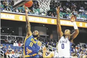  ?? CHUCK BURTON/AP ?? PITTSBURGH GUARD JAMARIUS BURTON (11) drives past Duke forward Dariq Whitehead (0) during the second half of a game at the Atlantic Coast Conference Tournament in Greensboro, N.C., on March 9.