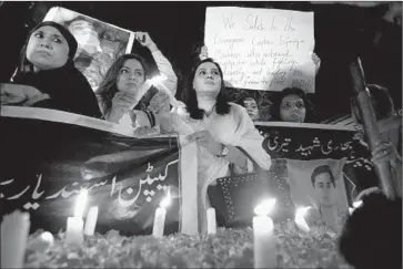  ?? Shakil Adil
Associated Press ?? CANDLES ARE LIGHTED for slain Pakistani soldiers in Karachi. Meanwhile, the Pakistani Taliban claimed responsibi­lity for an attack on a mosque inside an air force compound on the outskirts of Peshawar.