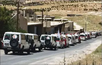  ?? AP PHOTO ?? This photo released by the government-controlled Syrian Central Military Media, shows ambulances of the Syrian Arab Red Crescent gathering in the Syrian border village of Fleeta.