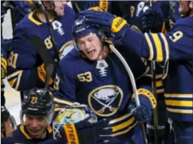  ?? JEFFREY T. BARNES — THE ASSOCIATED PRESS ?? Buffalo’s Jeff Skinner, center, celebrates his game-winning goal in overtime against the San Jose Sharks Tuesday.