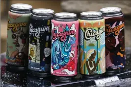  ?? JOSE M. OSORIO — CHICAGO TRIBUNE — TNS ?? Chicagwa drinking water cans feature designs created by local artists.