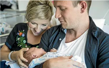  ?? PHOTO: BRADEN FASTIER/STUFF ?? Bec Brown and Nick Schryvers with baby Artie who was born on Thursday at Nelson Hospital. Nick only just made it to the birth after being stuck in Golden Bay during extropical cyclone Gita.