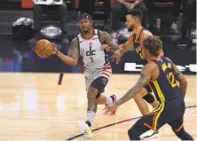  ?? Jed Jacobsohn / Associated Press ?? Washington’s Bradley Beal (3) got away with a travel late in the Wizards’ victory over the Warriors on Friday, the NBA said.