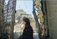  ?? ALAA AL-MARJANI / REUTERS ?? A displaced woman sits near the ruined Grand al-Nuri Mosque in the Old City of Mosul, Iraq, on Saturday after intense fighting between coalition forces and IS.