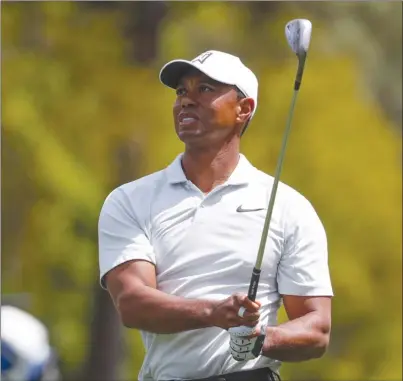  ?? The Associated Press ?? Tiger Woods watches his shot on the first hole during the second round of the Masters on Friday in Augusta, Ga.