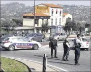  ?? PHILIPPE FARJON / ASSOCIATED PRESS ?? Police officers take positions after an attack Thursday at a high school in the town of Grasse in southern France. A student, 16, who had troubled relations with his peers, opened fire, officials said.