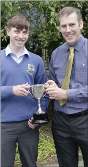  ??  ?? Sam Ireland, third year Sportspers­on of the Year, receives his award from Bill Maher.