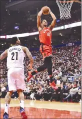  ?? The Canadian Press ?? Toronto Raptors guard DeMar DeRozan (10) scores as Denver Nuggets forward Wilson Chandler (21) looks on during first-half NBA action in Toronto on Tuesday.