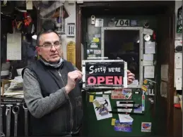  ?? Photo by Megan Gannon ?? SORRY WE’RE OPEN—Clark Reddaway holds the famous sign that welcomes customers into Builders.