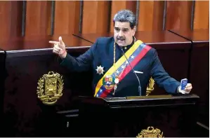  ?? (AP photo/ariana Cubillos, file) ?? Venezuelan President Nicolas Maduro holds a small copy of his nation’s constituti­on Wednesday during a ceremony marking the start of the judicial year at the Supreme Court in Caracas, Venezuela.