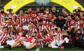  ?? Photograph: Pablo Garcia/AFP/Getty Images ?? Athletic Bilbao players celebrate with the trophy after beating Barcelona 3-2 in extra time.