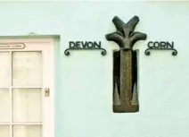  ??  ?? The distinctiv­e marker on the cottage where the county boundaries of Devon and Cornwall used to meet.