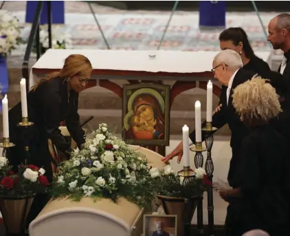  ?? ?? Sven‑Goran Eriksson's partner Yaniseth Alcides, left, and his father Sven Eriksson, right, touch his coffin during the funeral service at Fryksände church in Torsby, Sweden