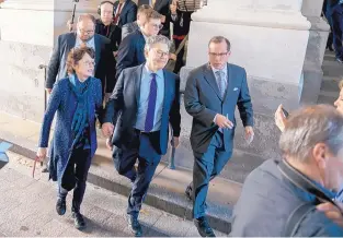  ?? ANDREW HARNIK/ASSOCIATED PRESS ?? Al Franken, D-Minn., holds hands with his wife, Franni Bryson, as he leaves the Capitol after speaking on the Senate floor on Thursday.