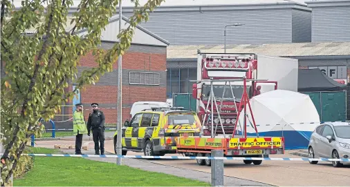  ??  ?? GRIM FIND: Police examine the Bulgarian-registered lorry in which 39 bodies were found at the Waterglade Industrial Park in Grays, Essex