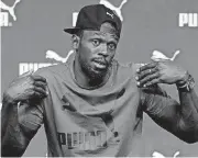  ??  ?? Jamaican athlete Usain Bolt gestures during a news conference ahead of the World Athletics championsh­ips in London on Tuesday.