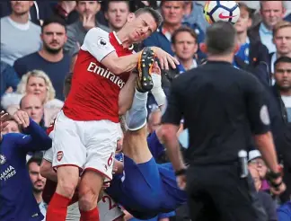  ?? REUTERS ?? Flying feet: Luiz’s bicycle kick came close to Koscielny’s head. He was booked for this...the straight red came later