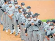  ?? AP ?? Hanwha Eagles players wearing face masks line up during the start of their game against SK Wyverns in Incheon, South Korea.