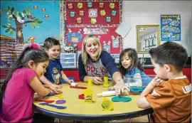  ?? RICARDO B. BRAZZIELL / AMERICAN-STATESMAN ?? Natalie Wimberley works on an arts project with pre-K students at Buda Elementary in March. Thanks to an initial $118 million in grant funding approved in the last legislativ­e session, high-quality standards are now in place for pre-K kids across the...