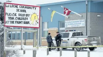  ?? THE CANADIAN PRESS FILES ?? RCMP officers stand outside the La Loche Community School on Jan. 25, 2016, after a teenaged shooter killed two and injured seven. The shooter is set to be sentenced on Friday.