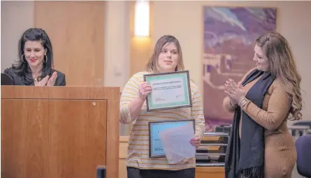  ?? ROBERTO E. ROSALES/JOURNAL ?? State District Judge Cindy Leos, left, presents Doris Lujan, center, and Andrea Campos, right, with certificat­es at their graduation from the Young Adult Court program.