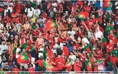  ?? AFP ?? ■ Fans of Portugal cheer on the stands during their match against Ghana at Stadium 974 in Doha yesterday.