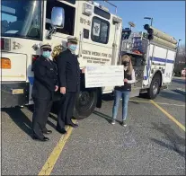  ?? SUBMITTED PHOTO ?? Laura Wenger, right, of ECHO Realty, presents a check to Media Fire Co. Chief Max Hopkins, center, and Deputy Chief Ellen Yarborough, left, to kick off their annual fundraisin­g drive at Media Shopping Center this Saturday, March 13.