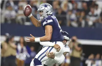  ?? (Matthew Emmons-USA TODAY Sports) ?? Dallas Cowboys quarterbac­k Dak Prescott (4) is sacked in the fourth quarter by Tennessee Titans linebacker Harold Landry III (58) at AT&amp;T Stadium.